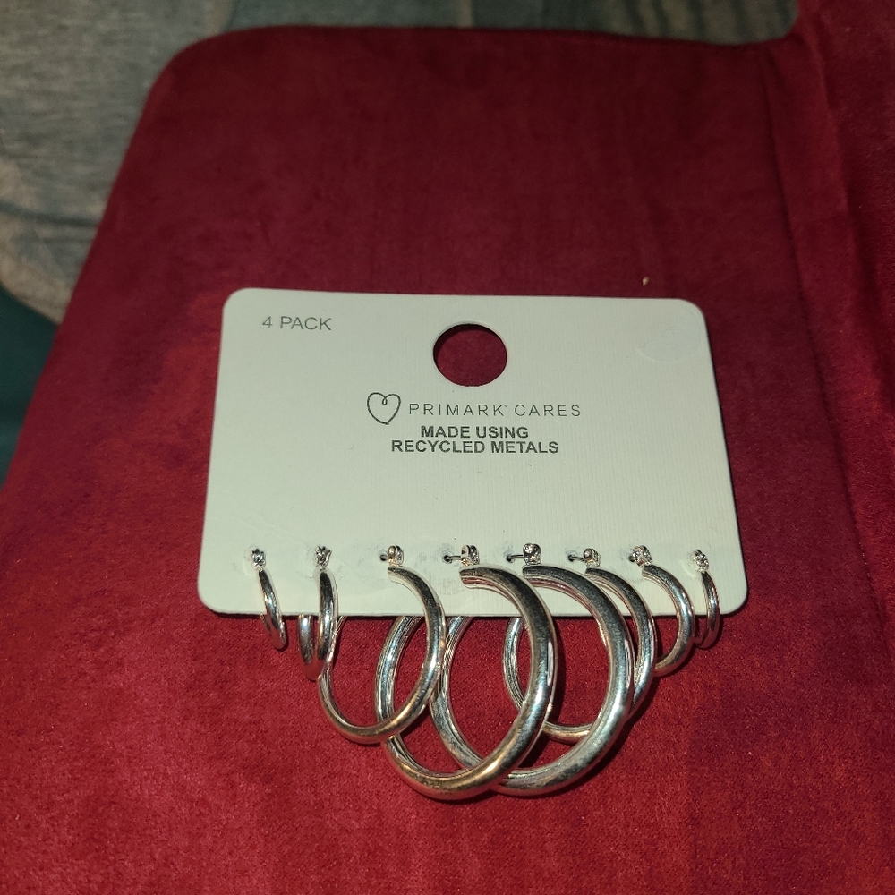 4 pair various size Silver Primark Cares earrings